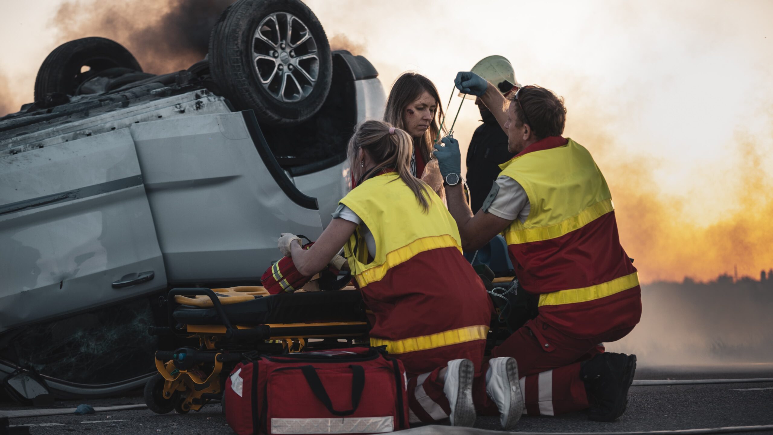 emergency responders assisting at car crash scene on the highway