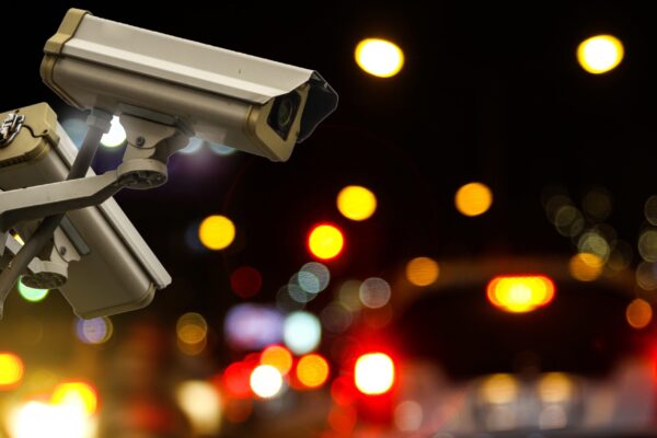 Outdoor CCTV monitoring at a road, security cameras at night traffic camera footage capturing a car accident at a busy intersection