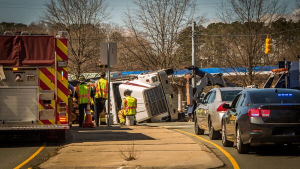 A truck accident scene with police officers taking notes and photographing the site Evidence gathering at commercial truck accident scene