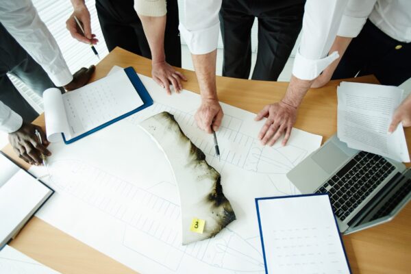 ntbs investigators examining airplane wreckage at a crash site Role of the NTSB in aviation accidents shown through investigators analyzing crash evidence
