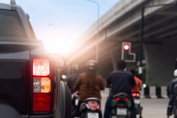 Urban intersection with turning car and motorcycle approaching motorcycle crash causes left-turn risk