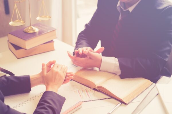 lawyer-client-consultation-catastrophic-injuries Image of a lawyer supporting a client starting a lawsuit for catastrophic injuries.