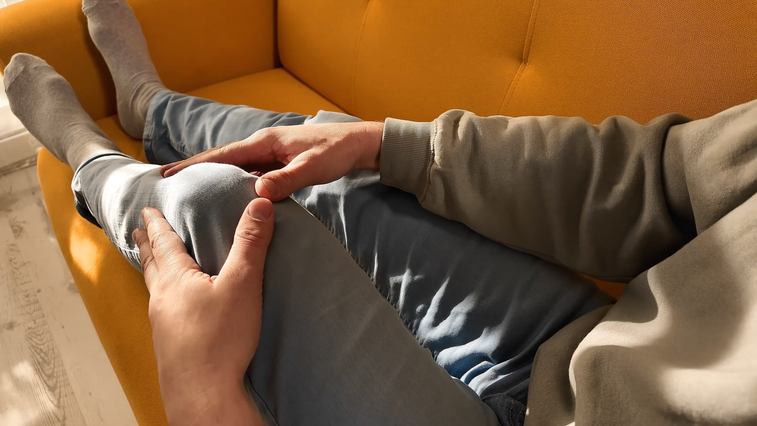 Person experiencing chronic pain at home after a car accident, representing pain and suffering damages in California