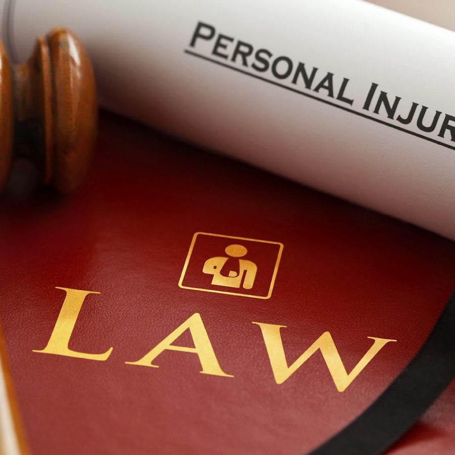 The-Impact-of-Comparative-Negligence-in-Personal-Injury-Cases-1 Gavel on a red law book with a rolled personal injury document, symbolizing legal services.