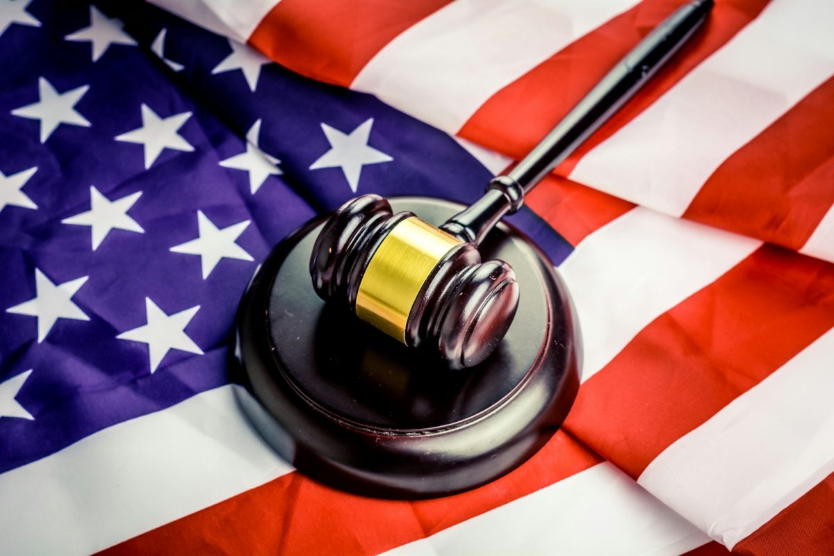Gavel on American flag symbolizing justice and law in the United States.